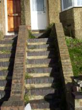 Stairs up to a home with no handrail